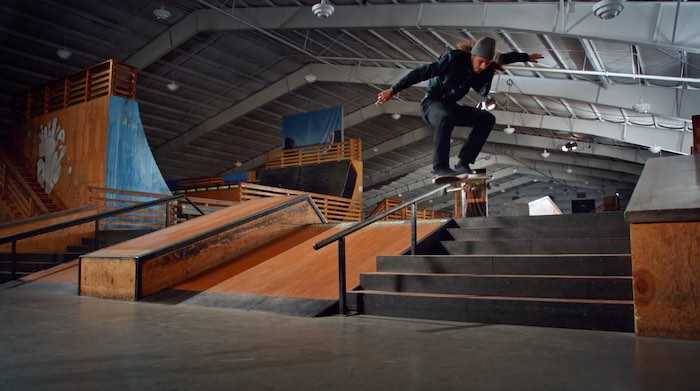 Riley Hawk kickflipping down a flight of stairs