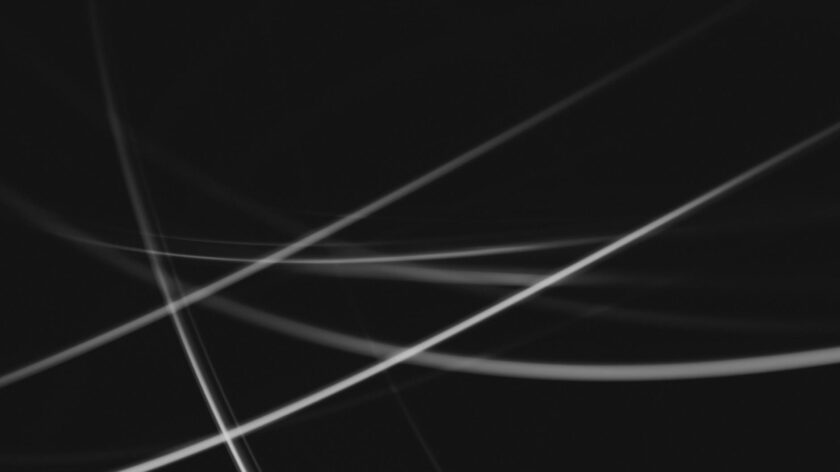 Dynamic abstract black and white light streaks, perfect for modern backgrounds and graphic design.