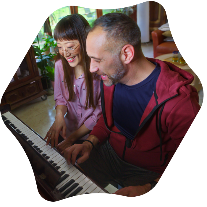Two people playing piano together