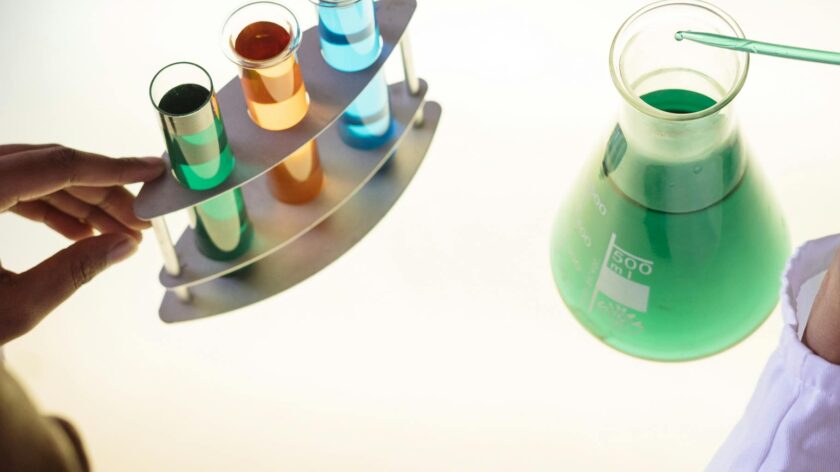 A vibrant science experiment involving colorful liquids in test tubes and a flask.