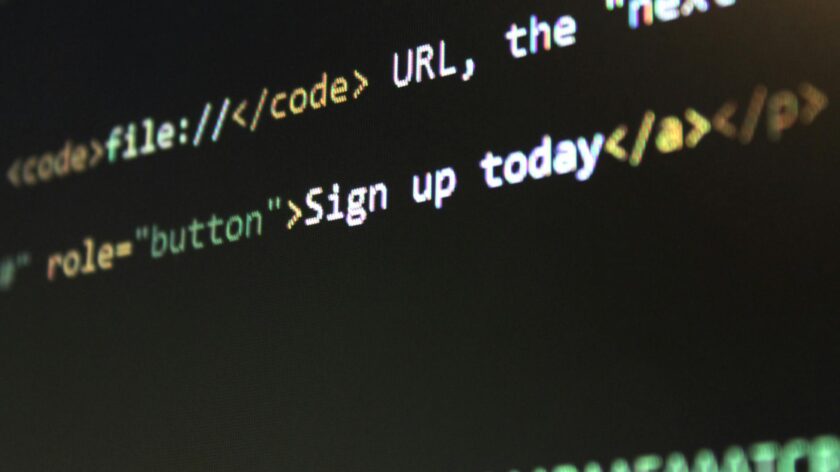 Detailed view of HTML and CSS code on a computer screen, concept of programming.