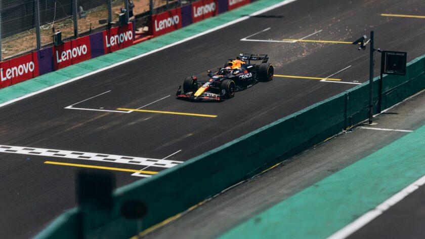 A Formula 1 car speeds down the track during a race, showcasing high performance.
