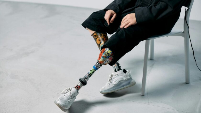 Colorful prosthetic legs in a minimalist studio, showcasing innovation and technology.