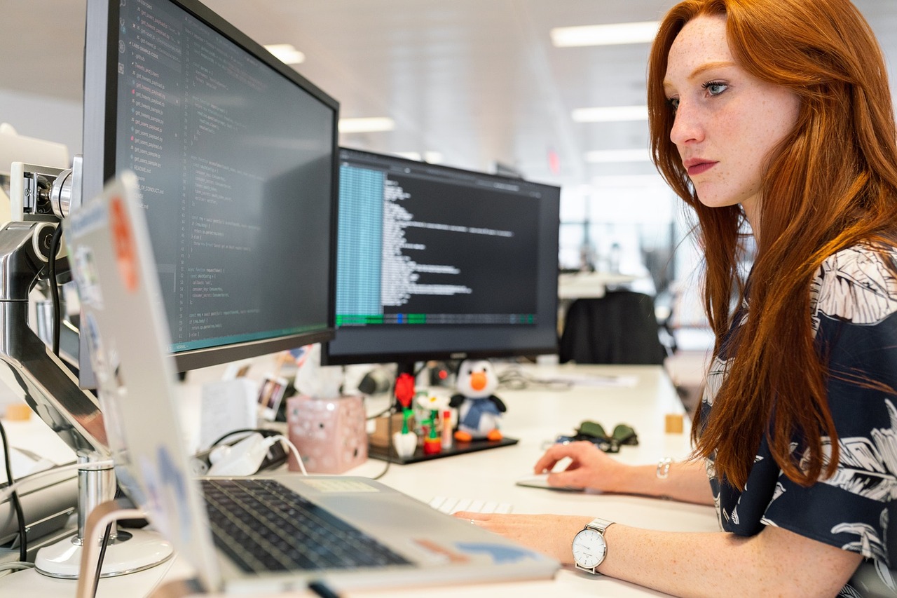 Software engineer working at a computer desk.
